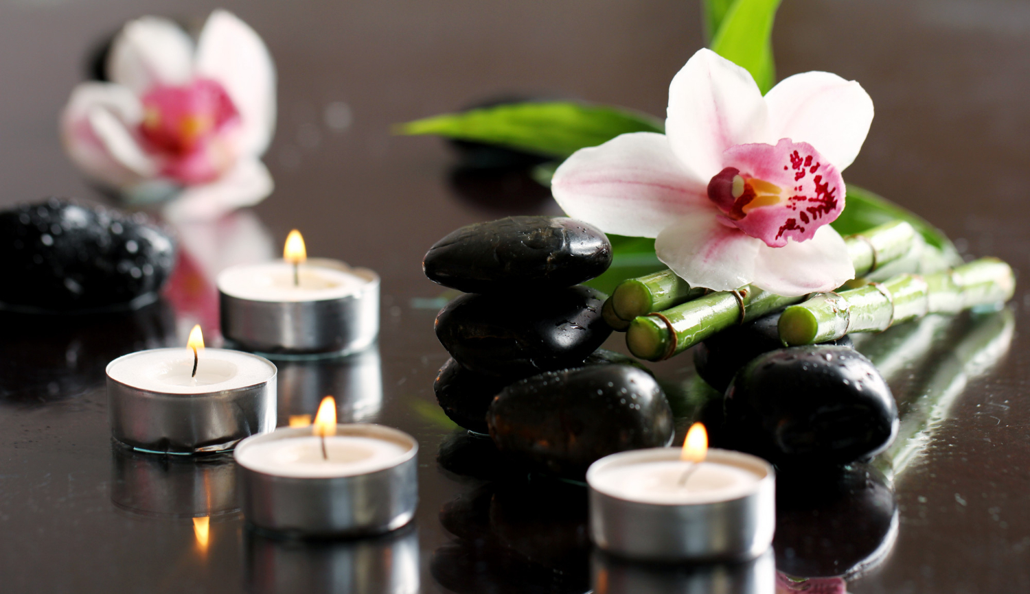 spa wellness massage stones flowers wooden tablecloth